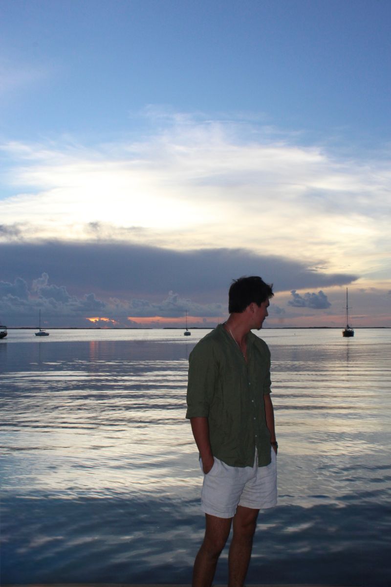 Cortland standing in the water at sunset