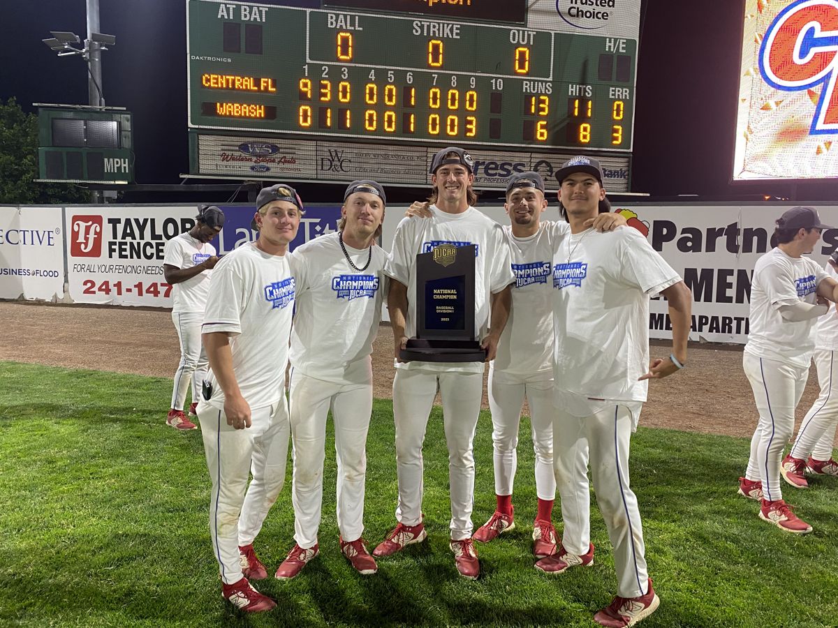 Central Florida team with the championship trophy under the scoreboard